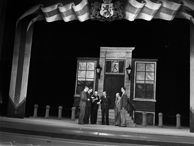 Provincieambtenaren repeteren 'Het lied van Zuid-Holland' in de Koninklijke Schouwburg, ter gelegenheid van het bezoek van het koninklijk paar aan Den Haag op 16 november.