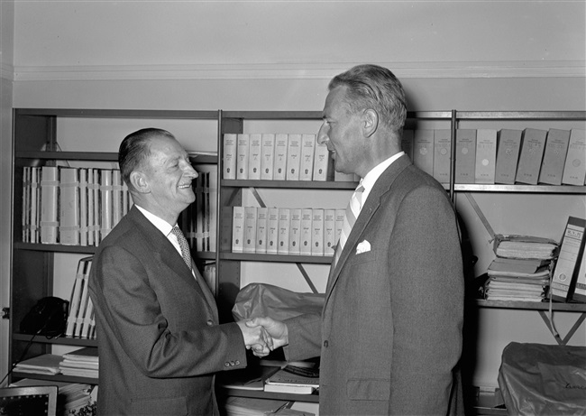 De heer Zegwaard, griffier van de Provinciale Staten (rechts) feliciteert de heer Dijkman met zijn ambtsjubileum.