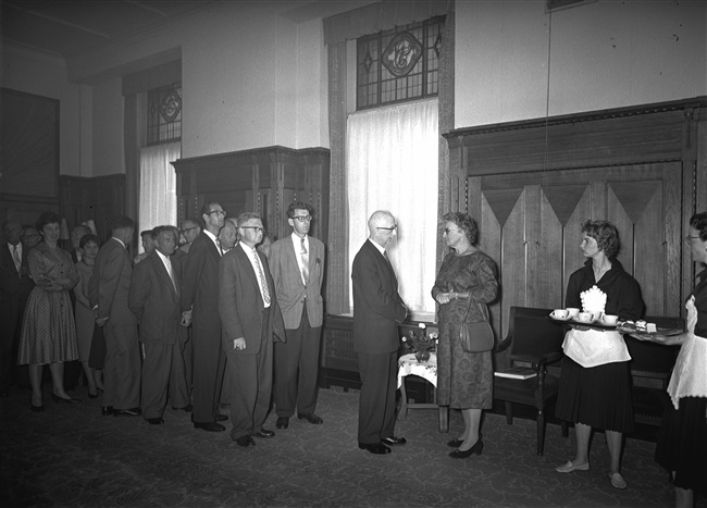 Ambtsjubileum van de heer Ormel, medewerker van de provincie Zuid-Holland, in het gebouw aan het Korte Voorhout 1. Gedeputeerde mr. Chr. A. de Ruyter-de Zeeuw feliciteert Ormel.