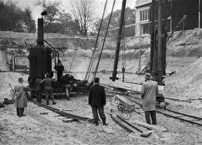 Proefheien voor de bouw van het nieuwe provinciehuis. Er wordt een proefpaal geheid om te zien of de paal voldoet aan de gestelde eisen.