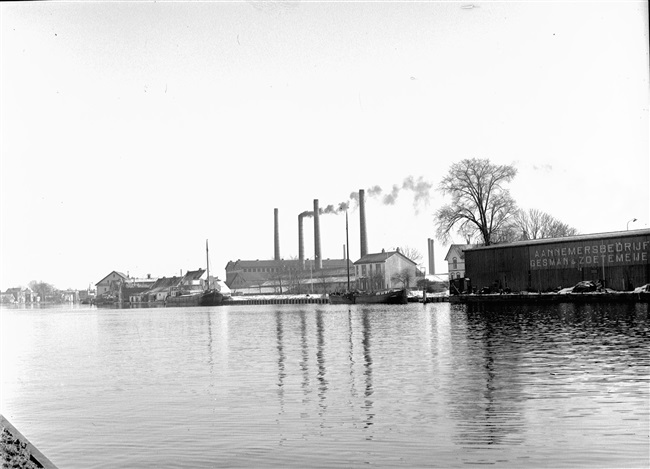 Industrie langs de Rijn. Rechts aannemersbedrijf Gesman en Zoetemeijer.